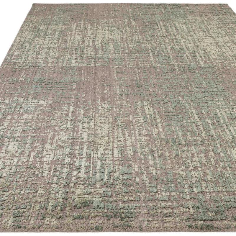 Large modern area rug with abstract green and beige pattern and textured surface