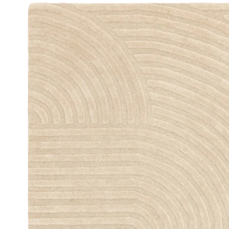 Beige area rug with modern textured geometric pattern, close-up of corner design