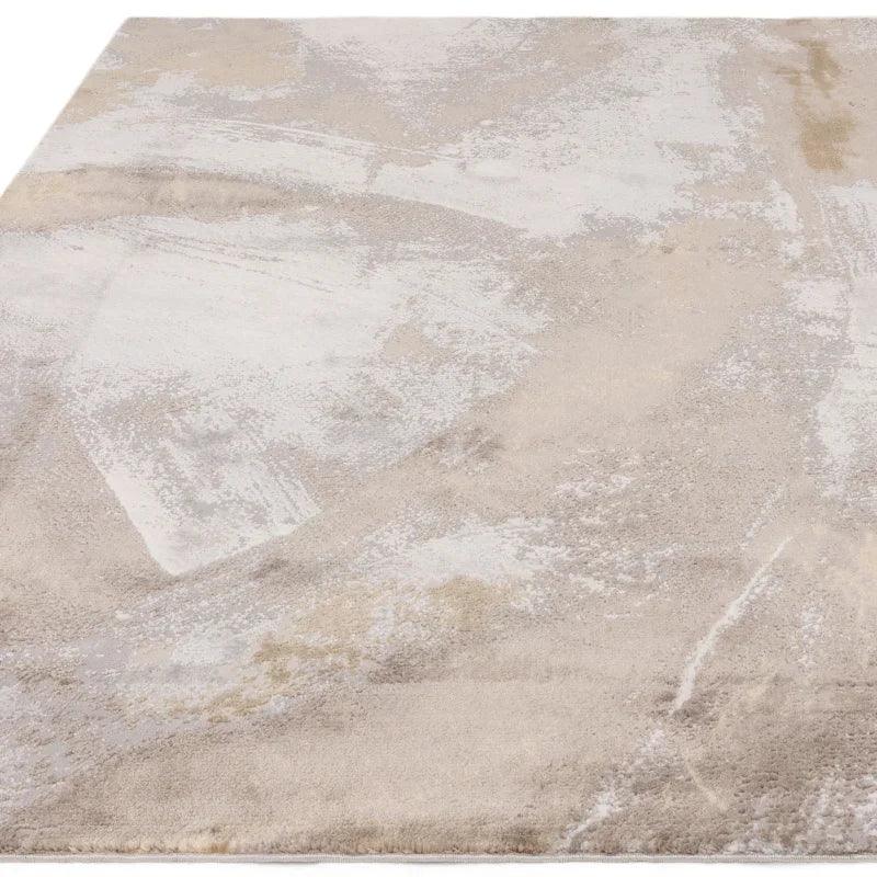 Beige and cream abstract area rug with soft textured pattern, shown from corner angle