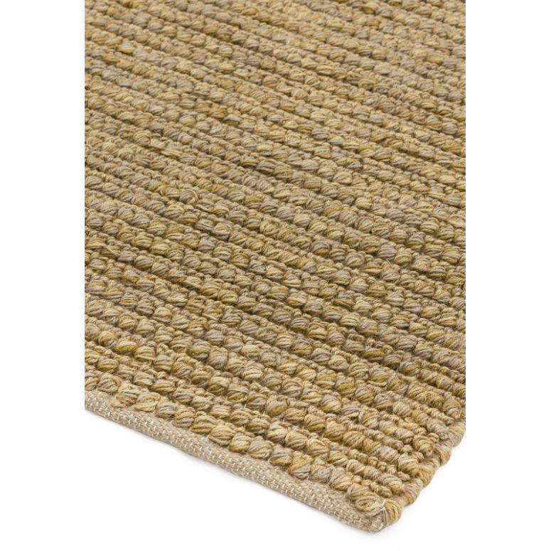 Natural woven jute rug corner with textured looped pattern