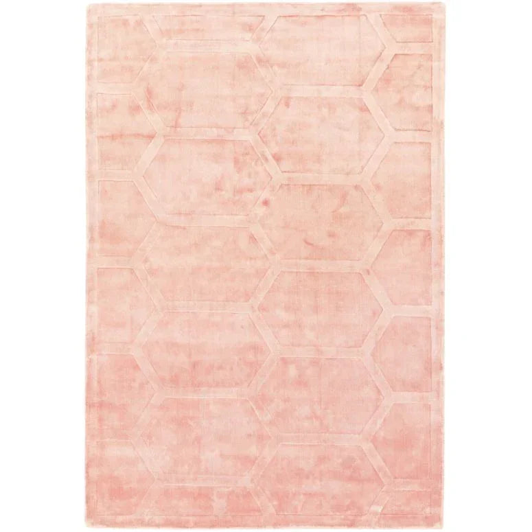 Blush pink area rug with subtle hexagonal pattern and soft texture, viewed from above