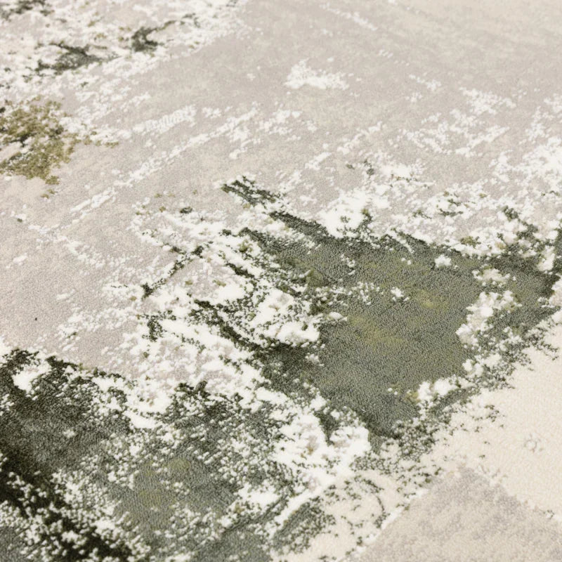 Abstract area rug with green, white, and beige textured pattern, close-up detail