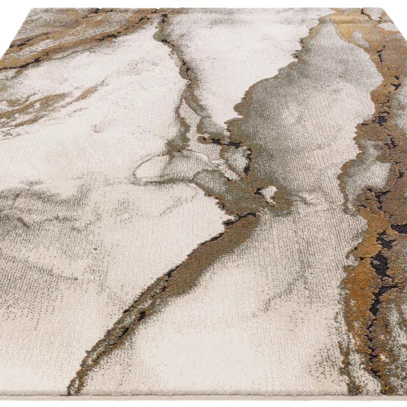 Modern abstract area rug with grey, beige and gold marbled pattern, angled top view