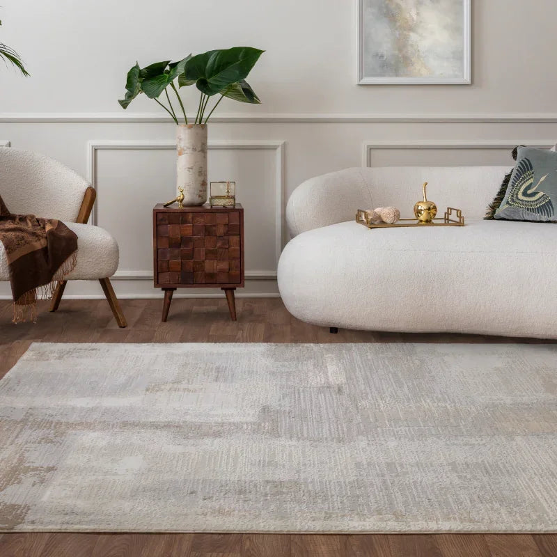 Neutral area rug on hardwood floor with white sofa, accent chair, and wooden side table