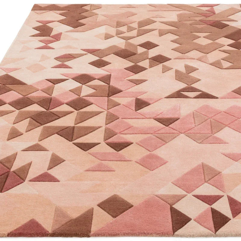 Pink geometric patterned area rug with raised triangle details on a cream background