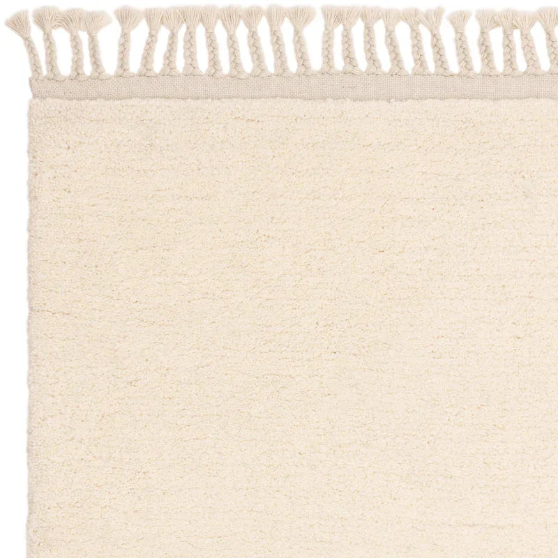 Cream woven rug with textured surface and fringe edge detail