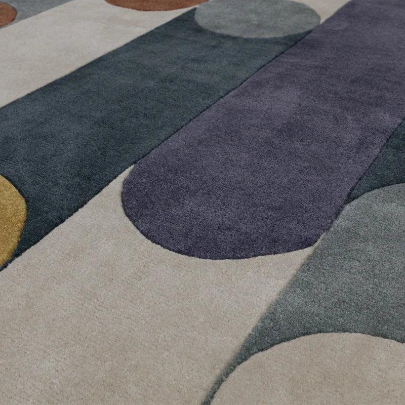 Modern area rug with geometric pattern in grey, beige, mustard, and blue tones