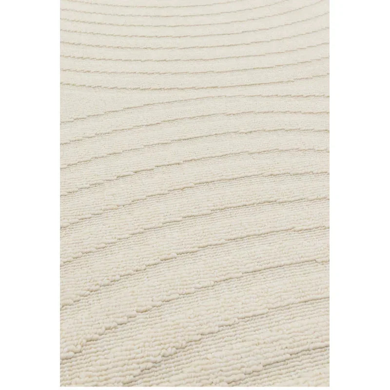 Cream textured rug with raised wave pattern closeup