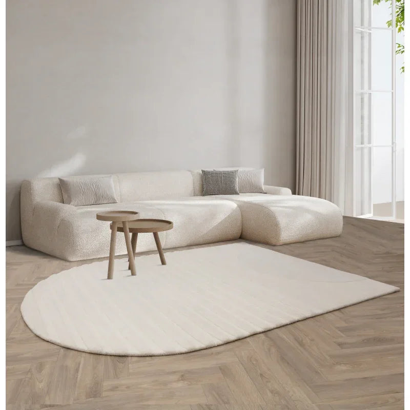 Cream corner sofa with textured upholstery, matching rug, and nesting tables in modern living room