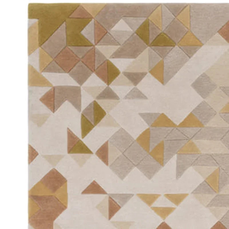 Close-up of geometric triangle-patterned rug in gold, terracotta and grey tones