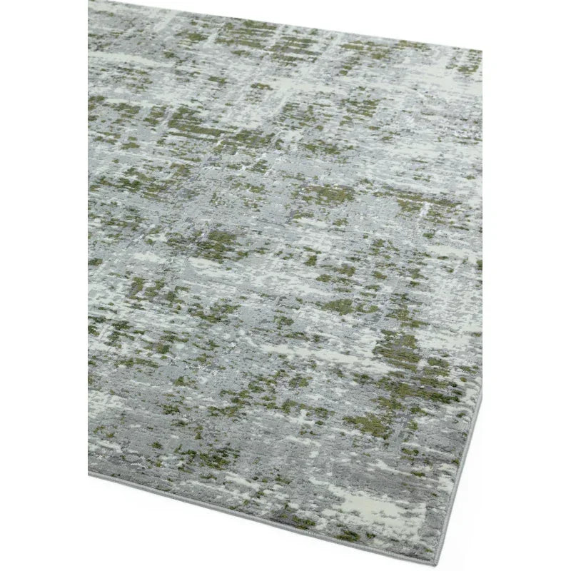 Modern area rug with abstract grey and green pattern, angled corner view on white background