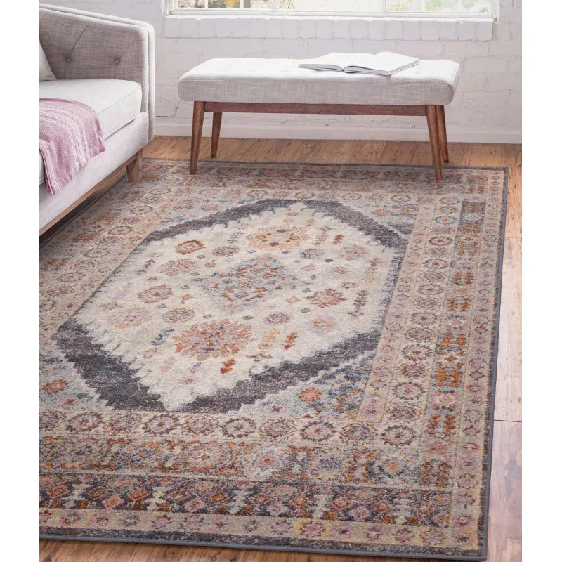 Traditional area rug with muted geometric pattern in living room on wooden floor