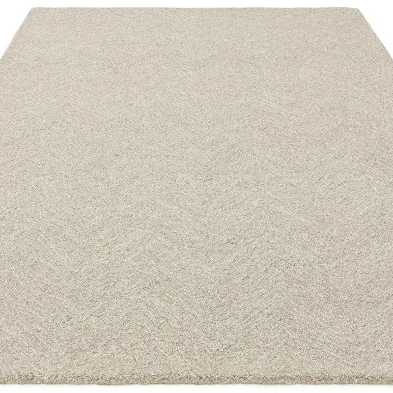 Beige textured area rug with subtle chevron pattern and soft pile