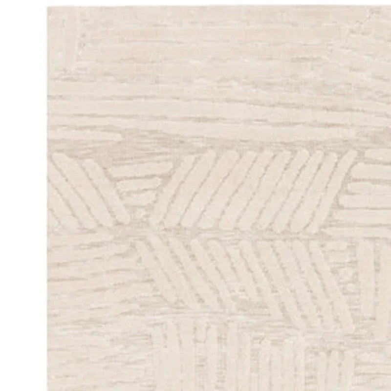 Beige patterned rug with textured geometric design and soft pile