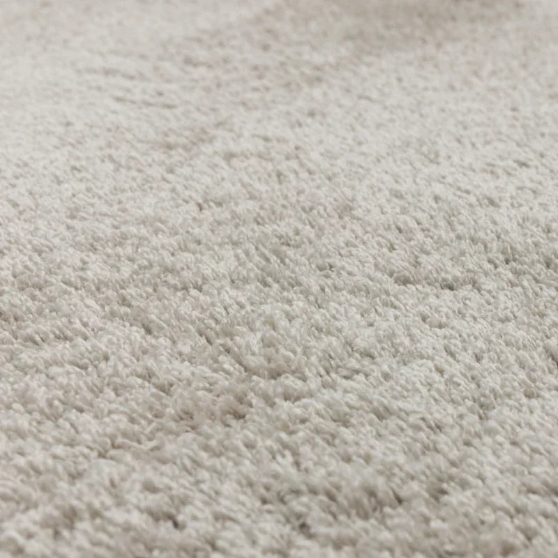Close up of soft cream shaggy rug texture and pile height detail