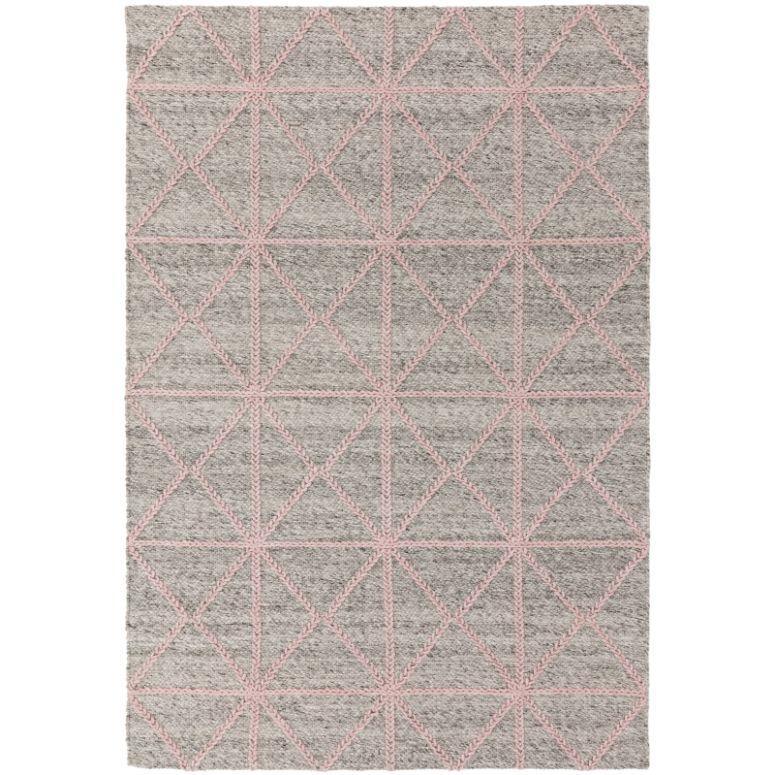 Grey wool rug with pink geometric diamond pattern, flat lay view