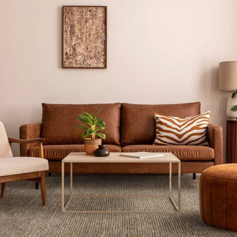 Brown fabric sofa with striped cushion and coffee table in modern living room setting