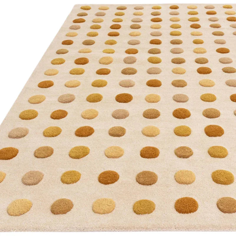 Beige area rug with brown and yellow polka dot pattern, close view of texture and design