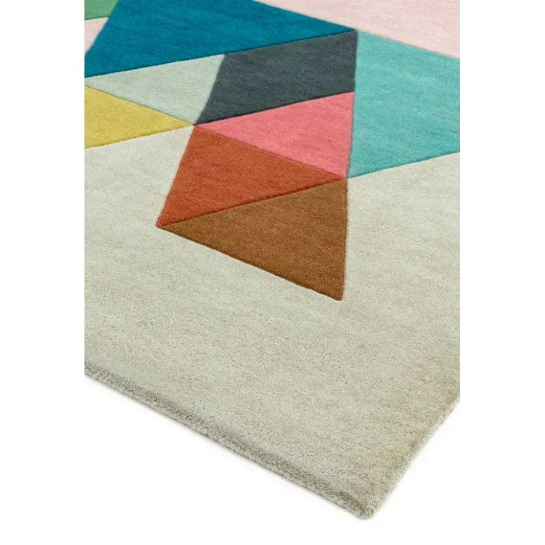 Modern geometric rug with colorful triangles on a cream background, angled corner view