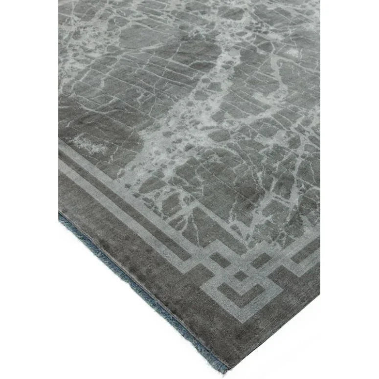 Grey area rug with marble effect and geometric border corner detail