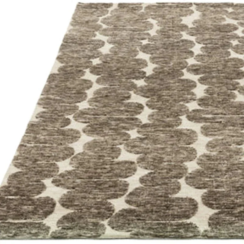 Beige and brown patterned area rug with abstract circular design
