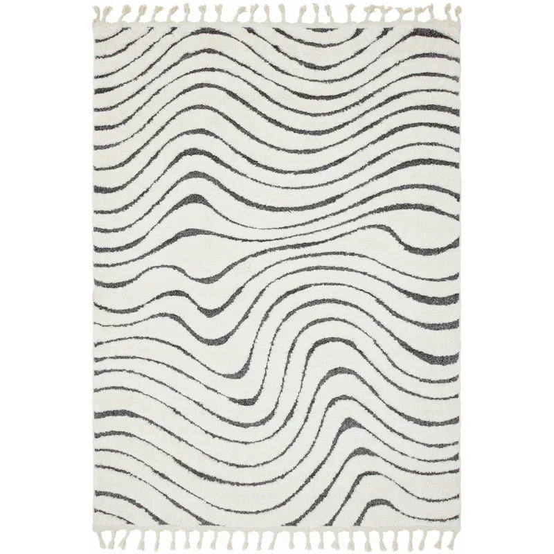 cream and black wavy pattern rug with tasselled edges, modern living room rug