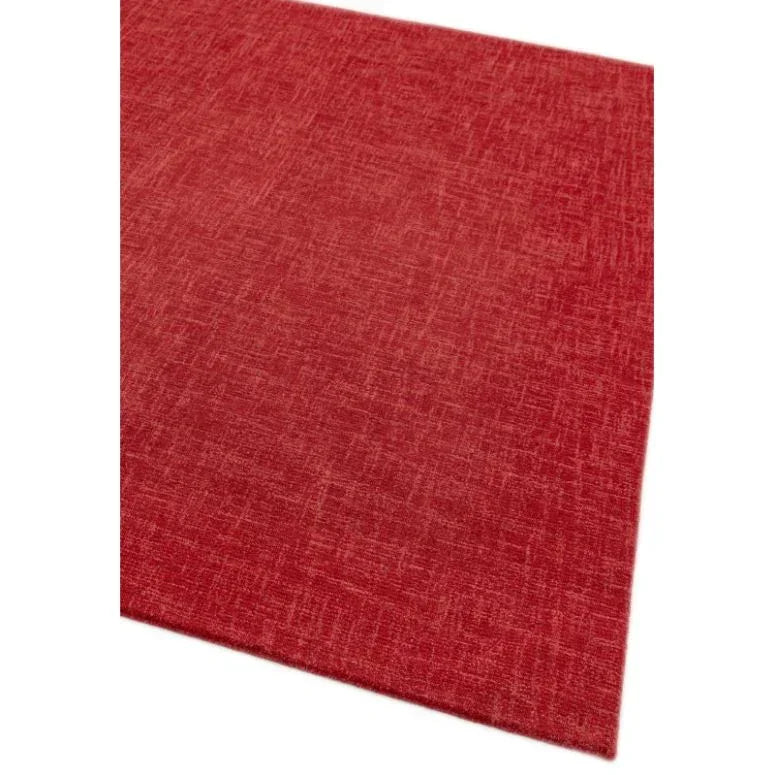 Red textured area rug with crosshatch pattern, corner view