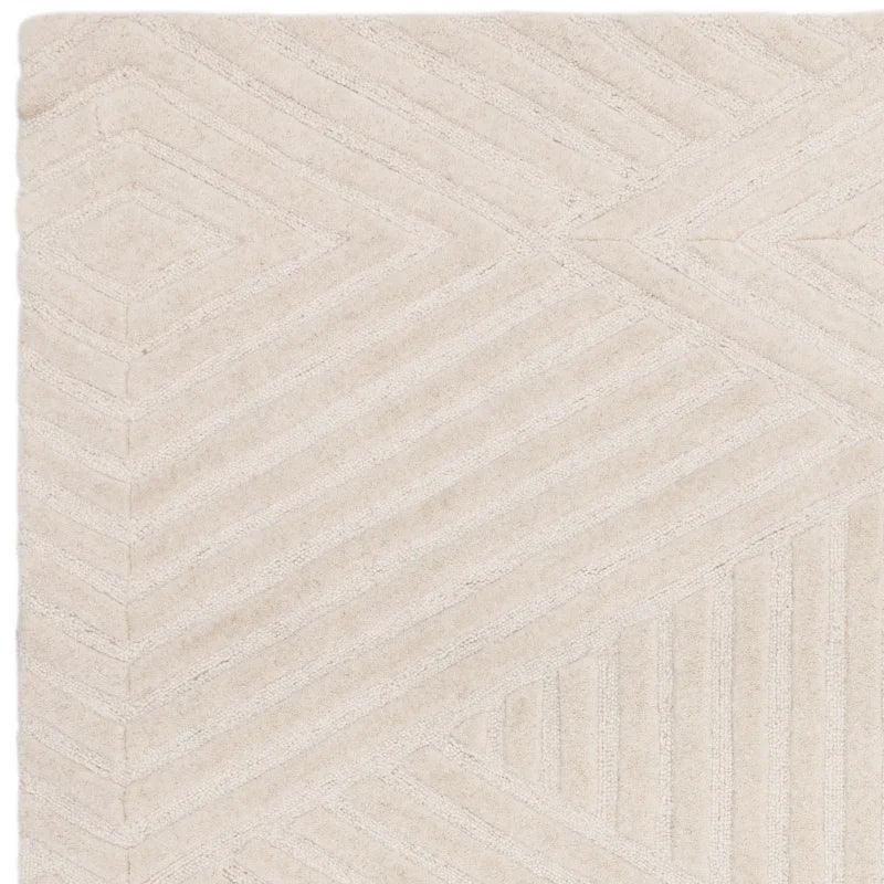 Beige textured rug with geometric line pattern, close-up of corner and surface detail
