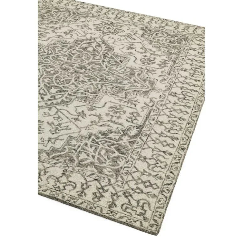 Grey and cream patterned rug with intricate border and central medallion design