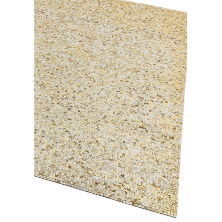Beige mosaic patterned area rug with gold accents shown from corner angle