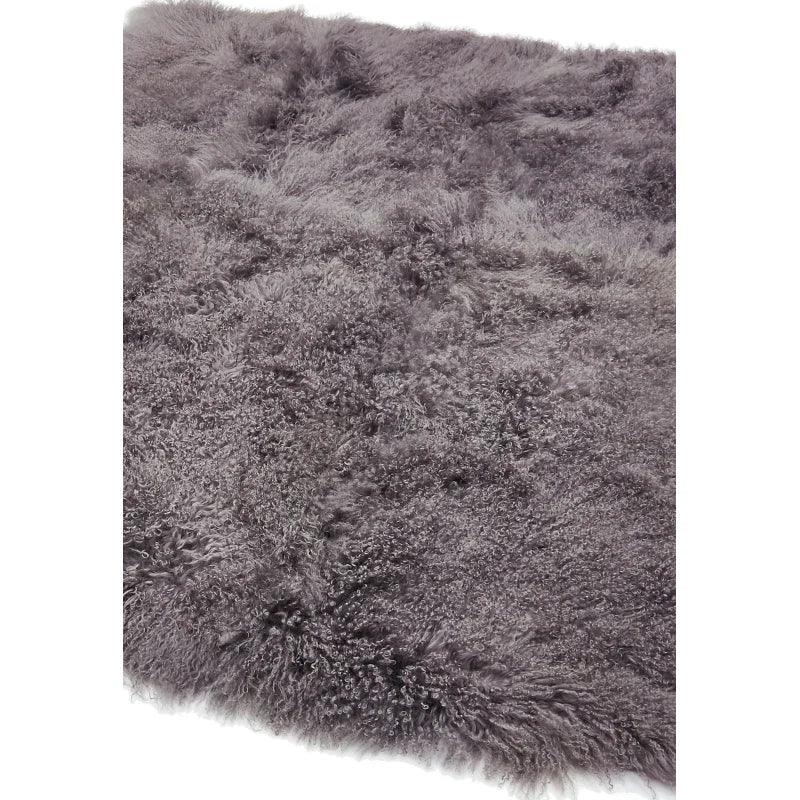 Close-up of grey shaggy rug with soft, fluffy texture and thick pile