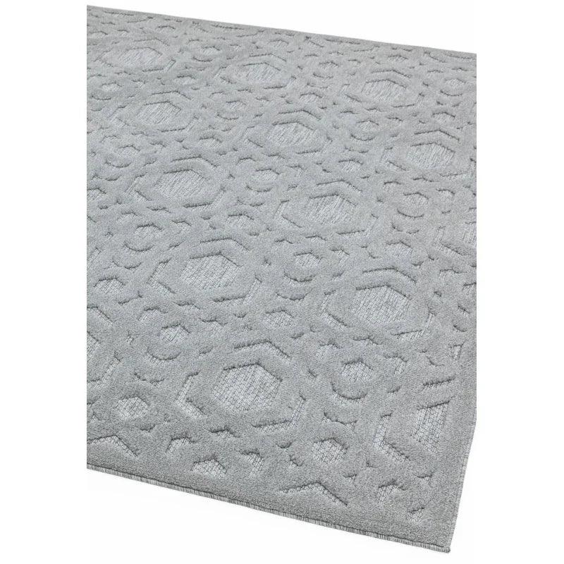 Light grey rug with raised geometric pattern and textured surface