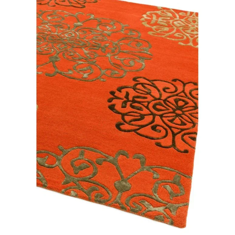 Red patterned area rug with raised olive green medallion design and border detail