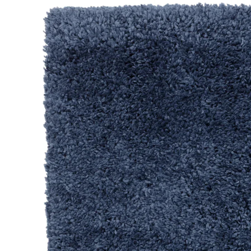 Close-up of blue shaggy rug texture and corner detail