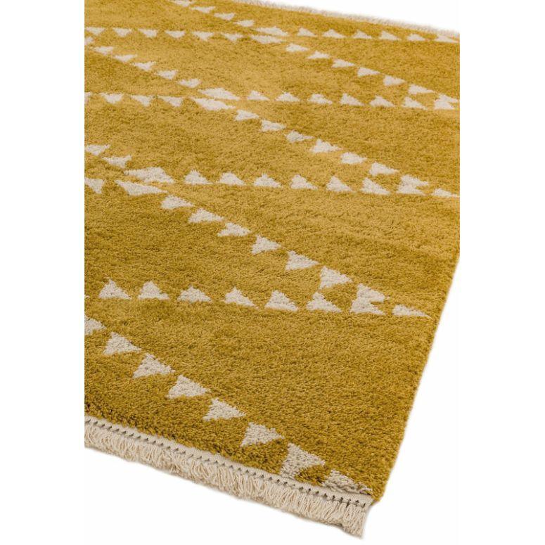 Mustard yellow geometric rug with cream triangle pattern and fringed edge