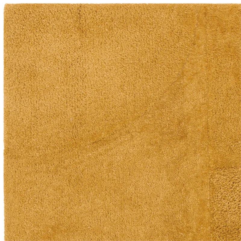 Close-up of mustard yellow rug with soft textured pile