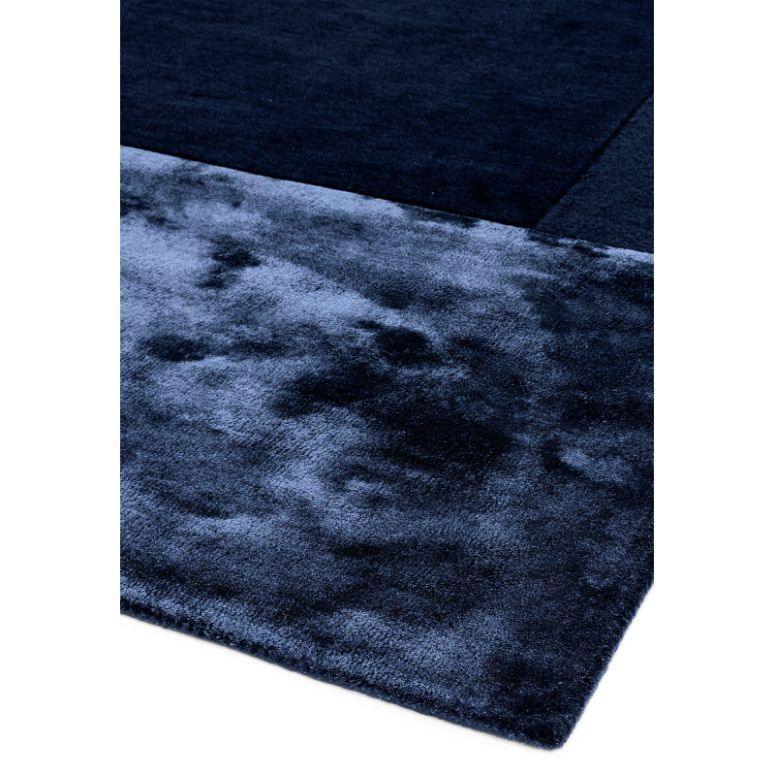 Close up of navy blue area rug with plush texture and soft sheen