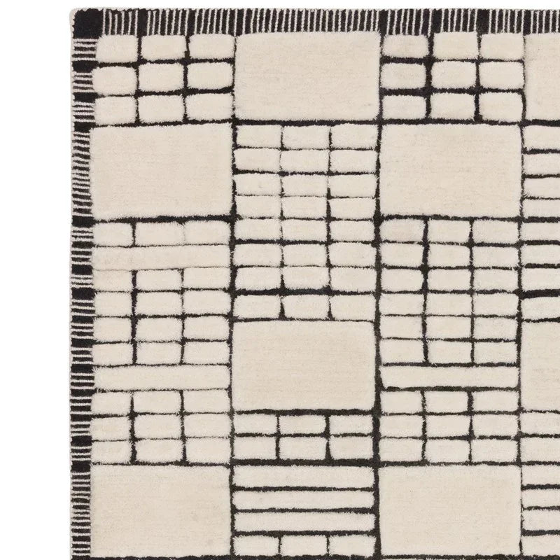 cream geometric rug with black grid pattern and soft textured surface