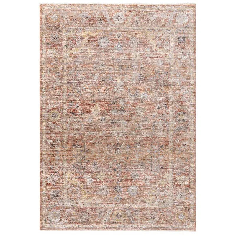 Patterned area rug with faded rust and beige tones and ornate floral design