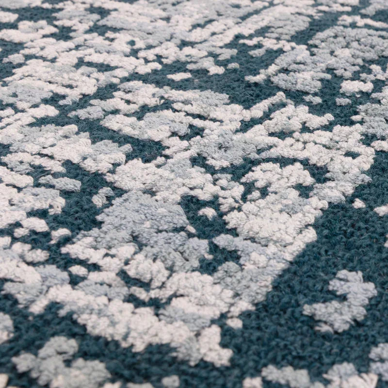 Textured blue and white patterned rug close-up with soft looped pile