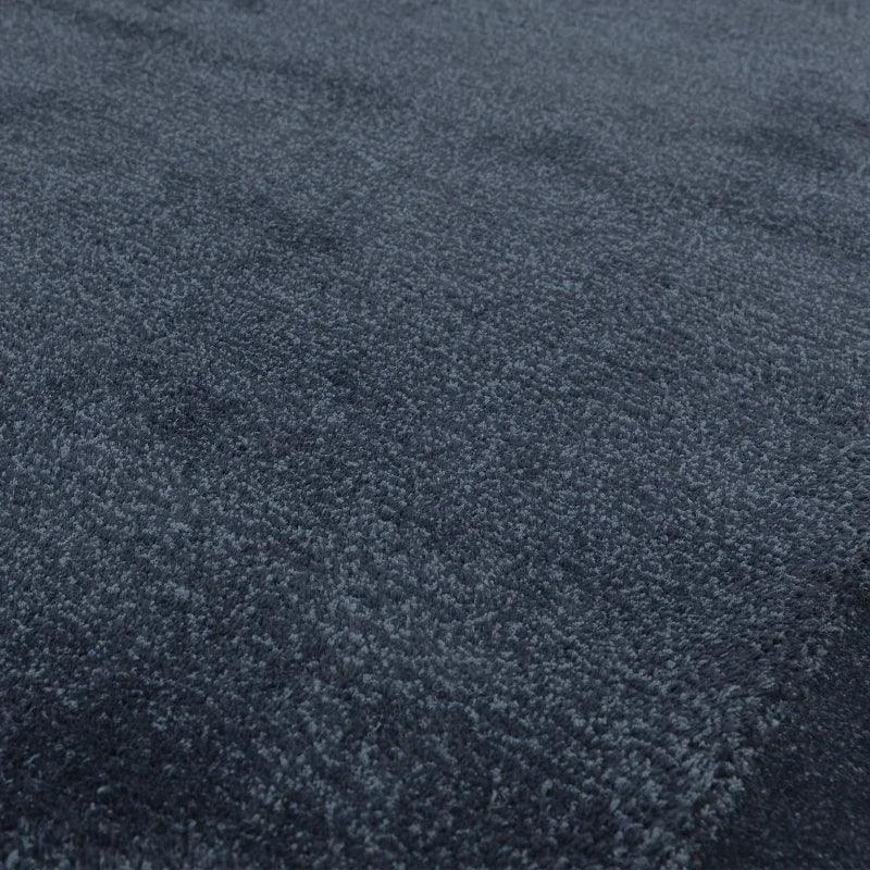 Dark grey shaggy rug close-up showing soft pile texture