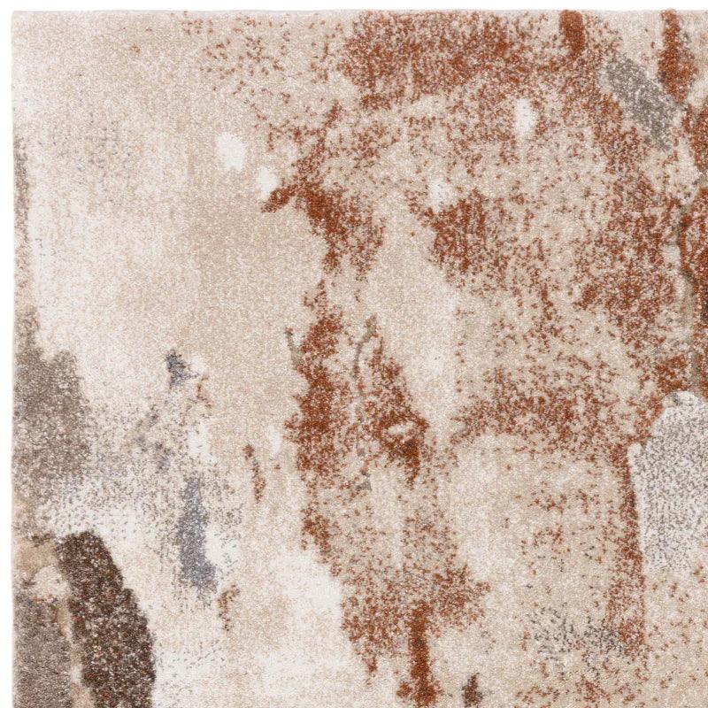 Modern abstract area rug with beige, brown, and grey pattern, close-up texture view