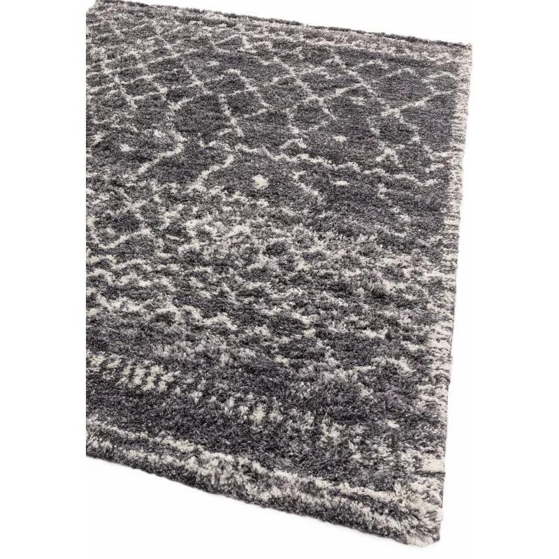 Grey shaggy rug with textured diamond pattern and thick pile, angled corner view