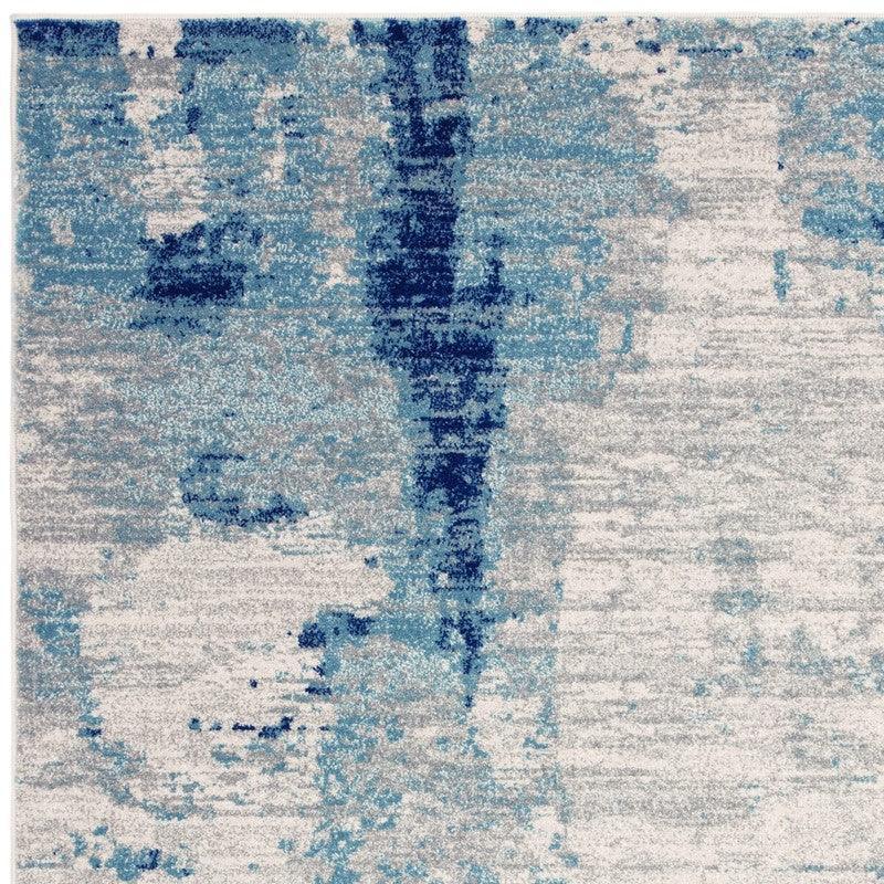 Abstract blue and white area rug with textured modern pattern