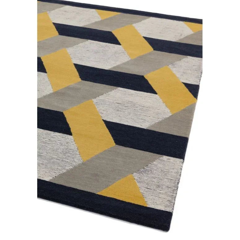 Geometric area rug with yellow, grey, black, and white pattern, angled corner view