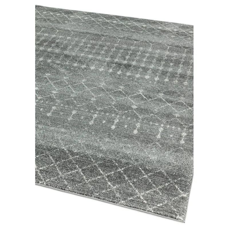 Grey patterned rug with subtle geometric design and soft texture, corner angle view