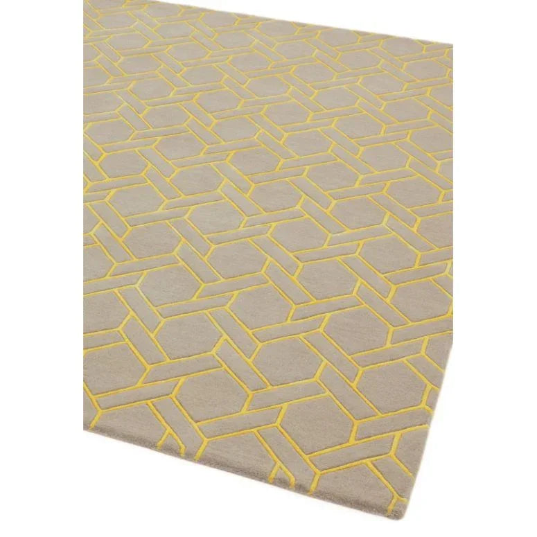 Beige geometric patterned rug with yellow accents and textured surface detail