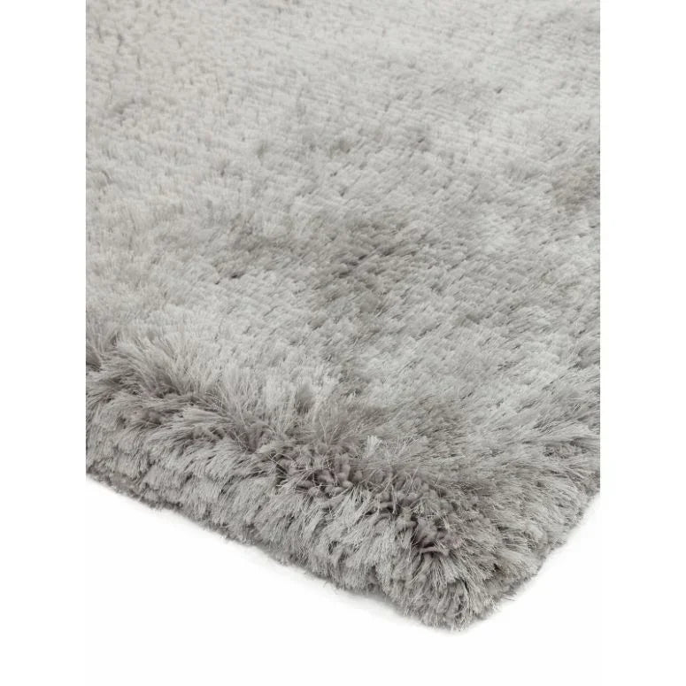 Close-up of grey shaggy rug corner with soft textured pile