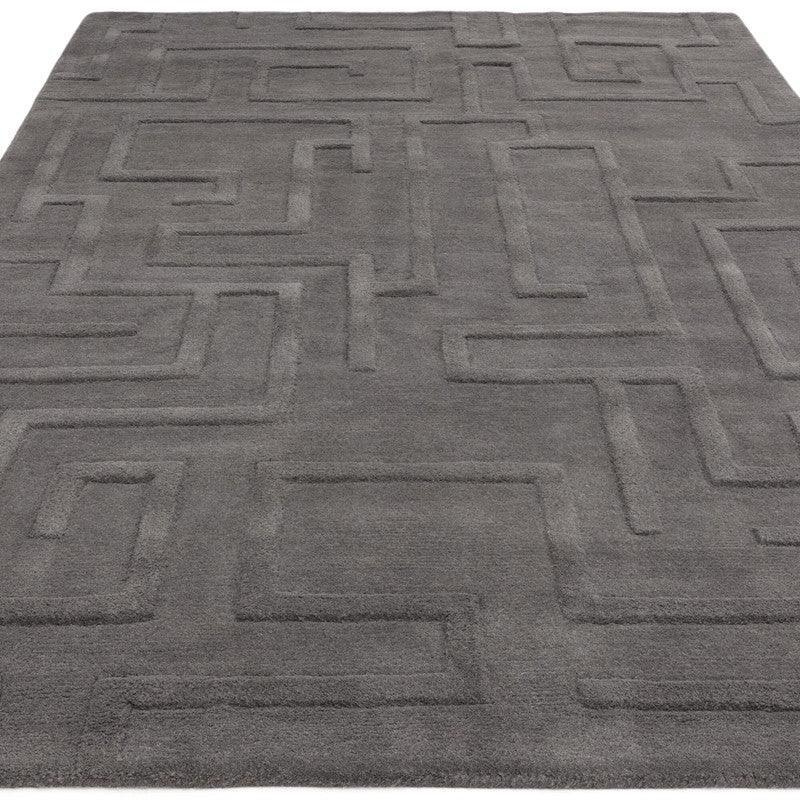 Grey geometric area rug with embossed maze pattern and soft pile texture
