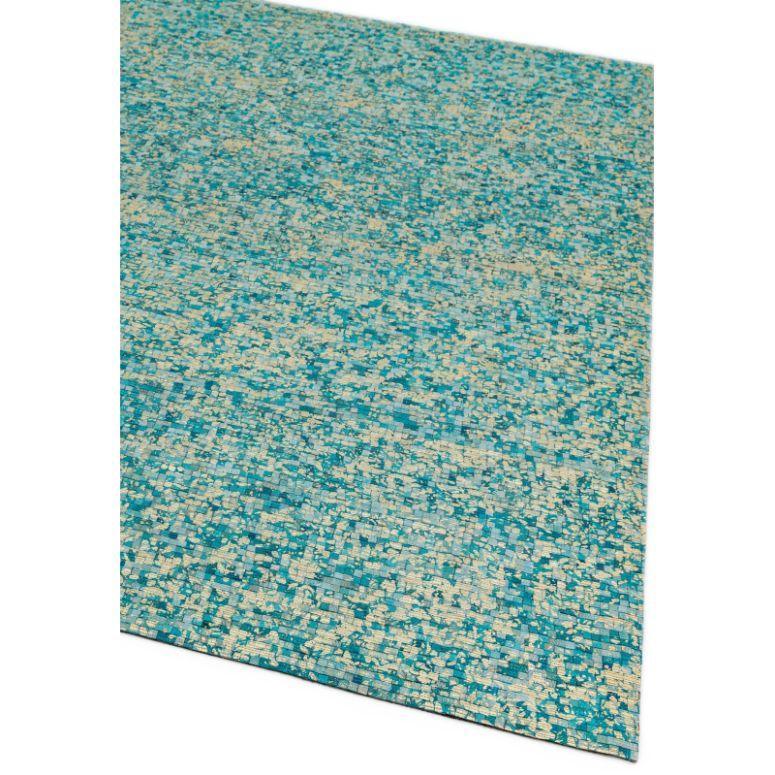 Blue and beige patterned rug with textured woven design, corner angle view